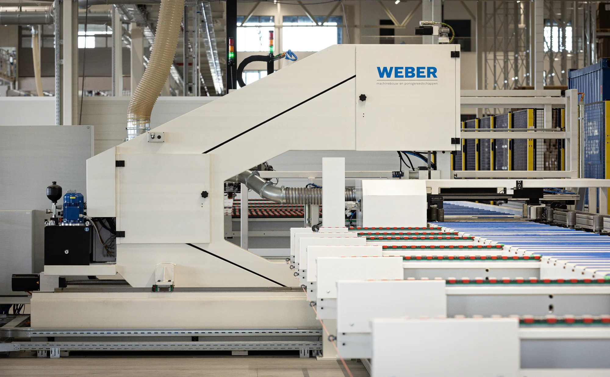 Maatwerk lintzaag voor het zagen en schulpen van sandwichpanelen, voorzien van automatisch afvaltransport. Door batch onafhankelijk te zagen wordt wordt restafval aanzienlijk verminderd.